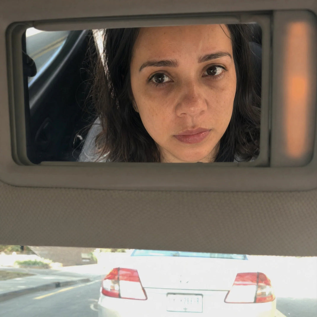 Woman noticing her appearance during an everyday moment